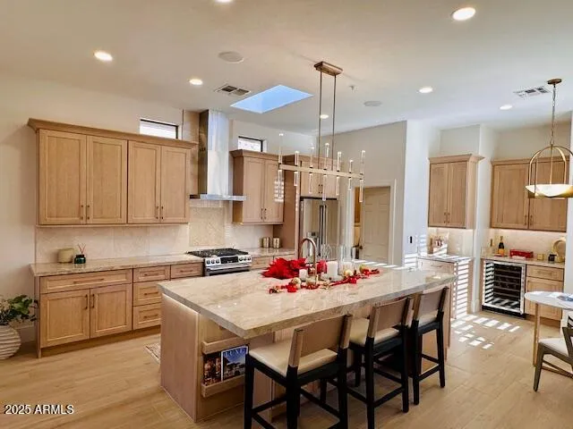 a large kitchen with kitchen island a stove a sink a dining table and chairs with wooden floor
