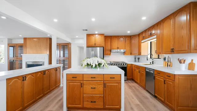 a bedroom with a large bed and wooden floor