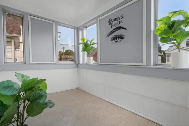 a white painted wall with a window