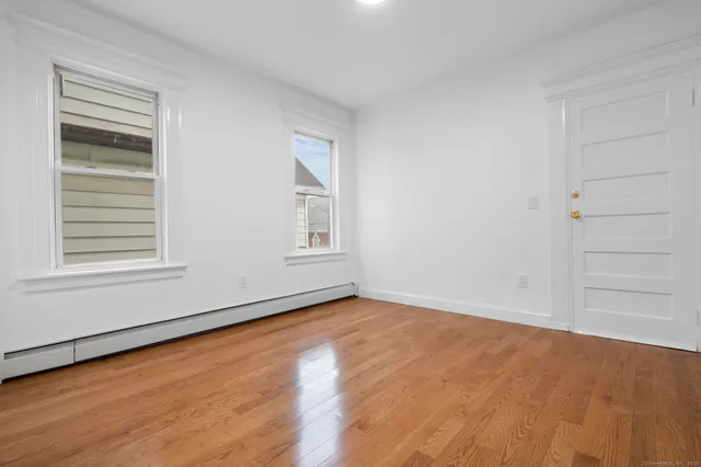 wooden floor in an empty room with a window
