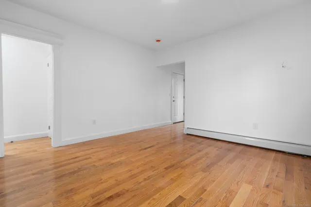 a view of an empty room and wooden floor