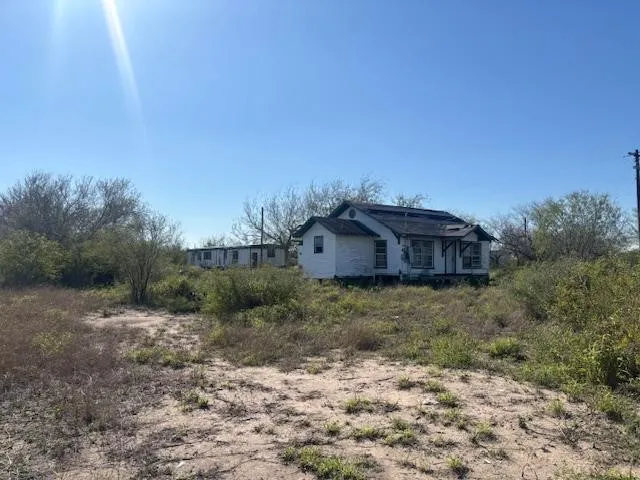 a view of a barn in the middle of a field