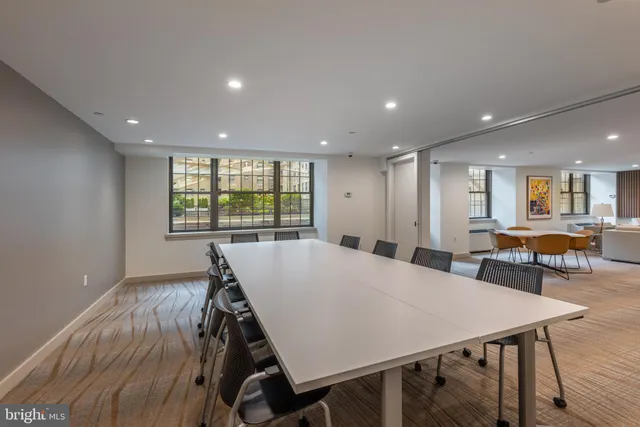 a living room with furniture a rug and a large window