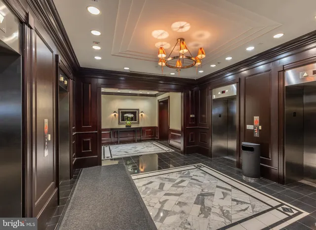a living room with fireplace furniture and a large window