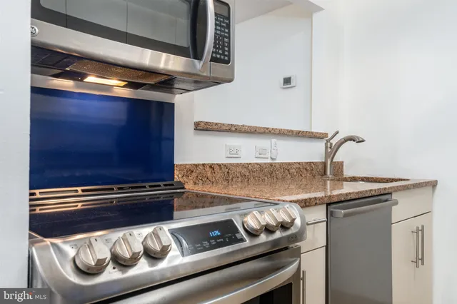 a kitchen with a stove and a sink