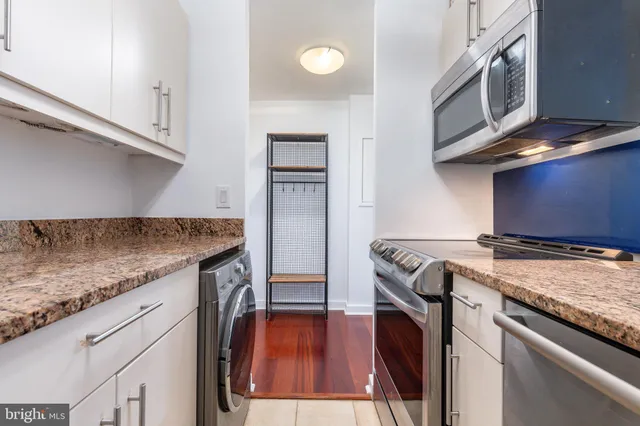a kitchen with granite countertop a stove and a sink