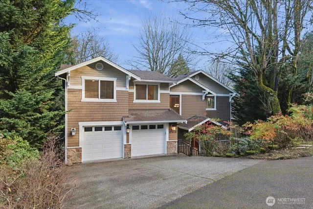 a front view of house with yard and trees in the background