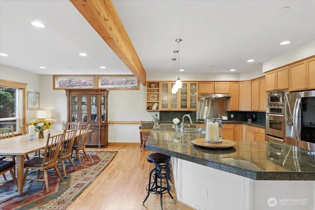 a kitchen with lots of counter top space and stainless steel appliances