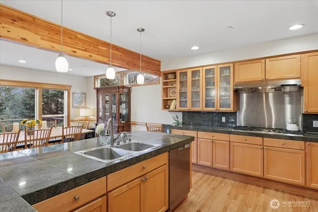 a kitchen with granite countertop a sink and cabinets