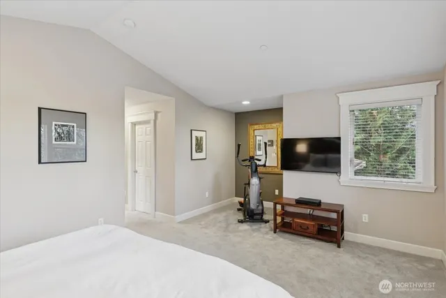 a bedroom with furniture and a flat screen tv