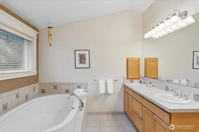 a bath room with a bathtub and a sink