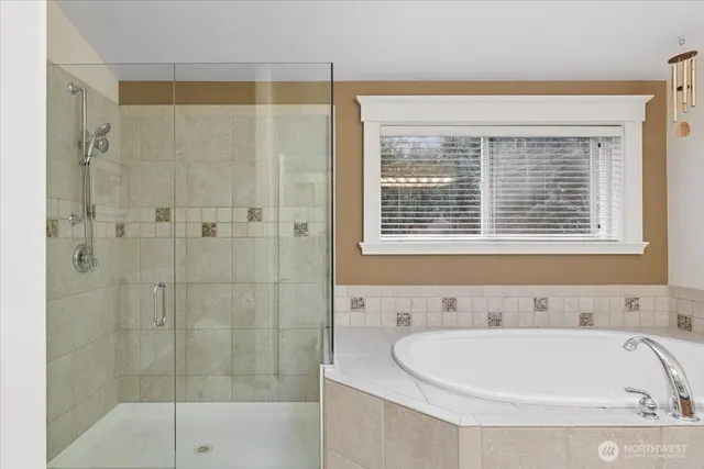 a bathroom with a bathtub and shower