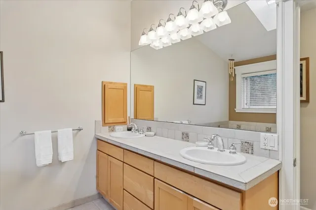 a bathroom with a sink vanity and a mirror