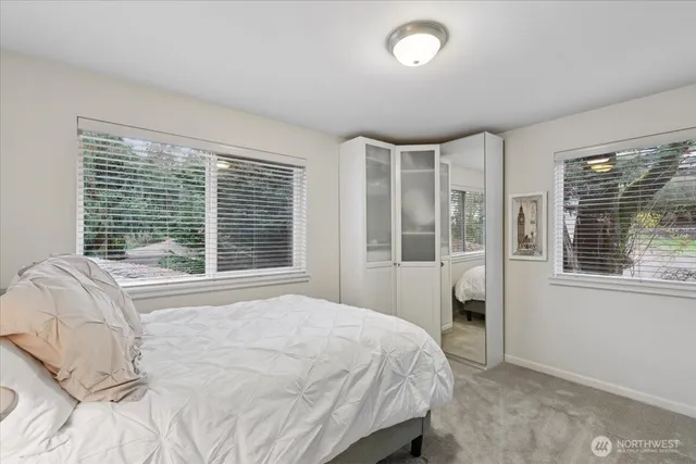 a bedroom with a large bed and a large window