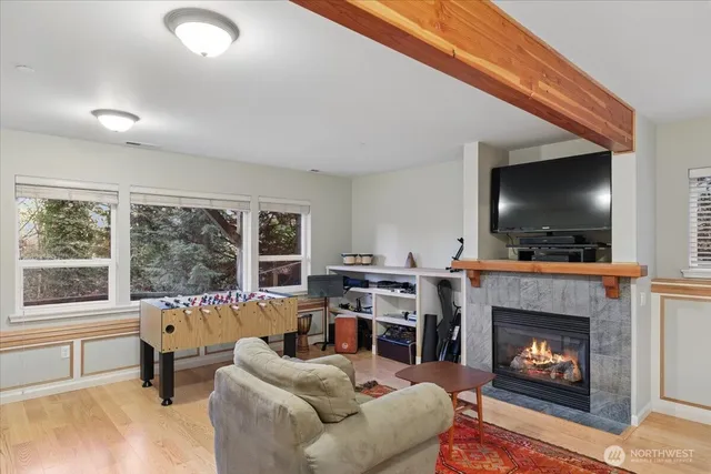 a living room with furniture a flat screen tv and a fireplace