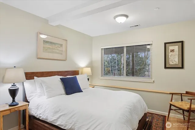 a bedroom with a bed and window