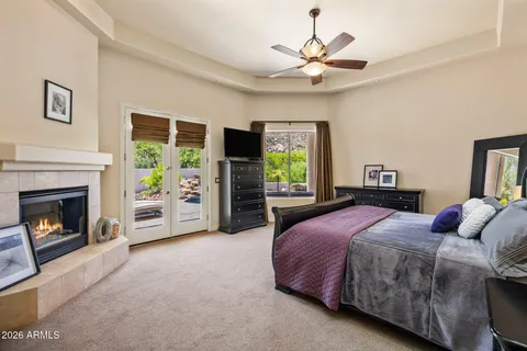 a spacious bedroom with a bed and a fireplace