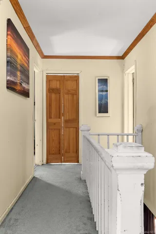 a view of a white house with a big yard and large trees