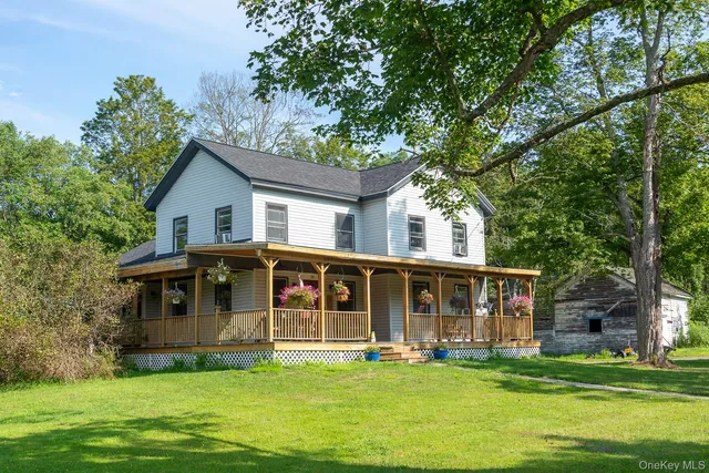 a view of a house with a yard patio and swimming pool