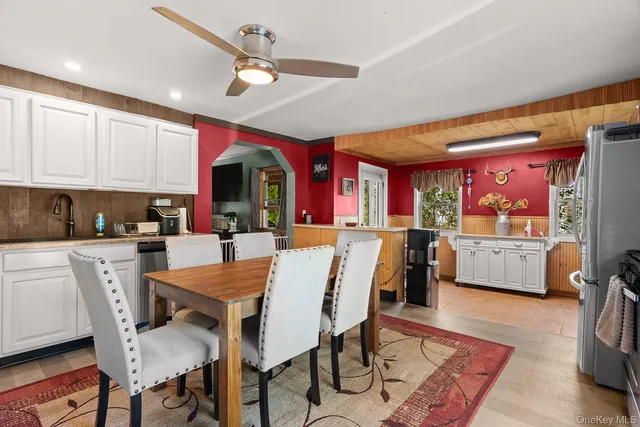 a view of a dining room with furniture and a chandelier