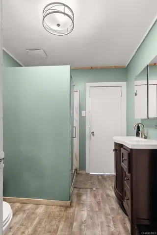 a view of a room that has a sink and a mirror