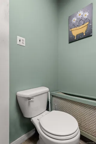 a white toilet sitting next to a shower