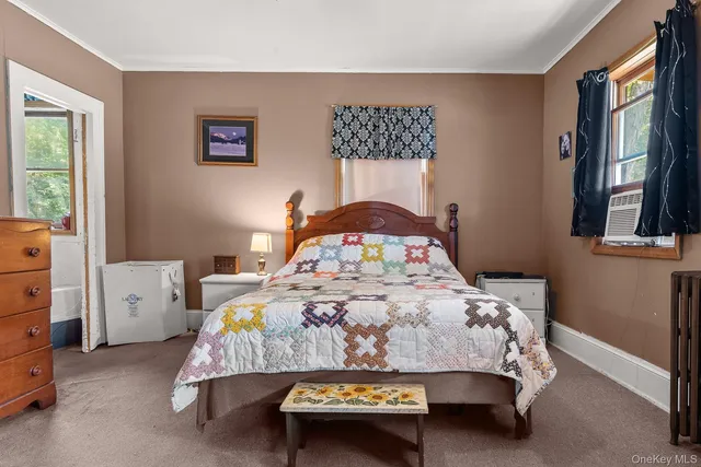 a bed sitting in a bedroom next to a window