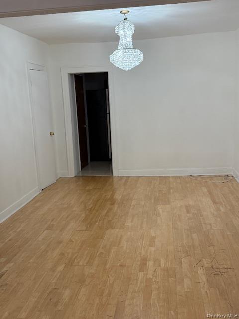 104-27 124th Street Queens, NY 11419 - Photo 7 of 7 a view of an empty room with a chandelier