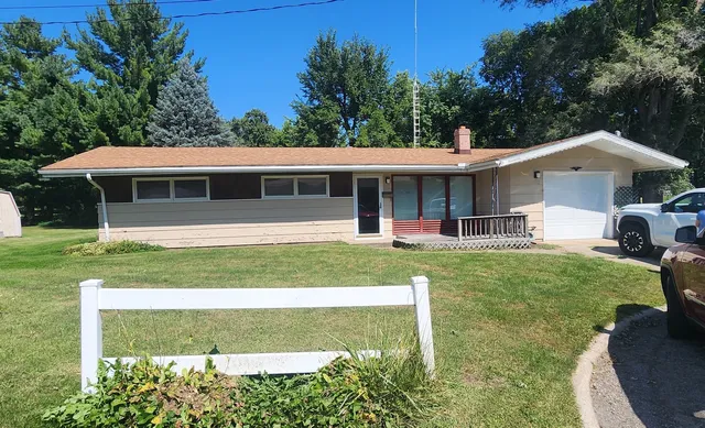 a view of a house with a yard patio and a small yard