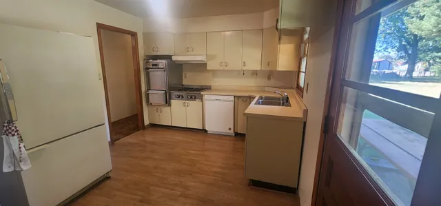 a kitchen with a refrigerator sink and stove
