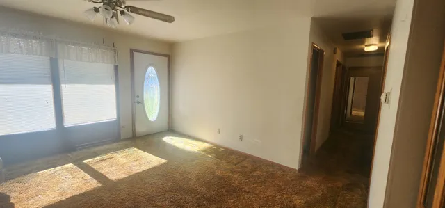 an empty room with windows and closet