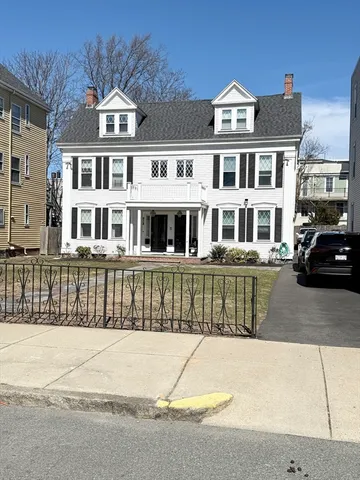 a front view of a residential apartment building with a yard