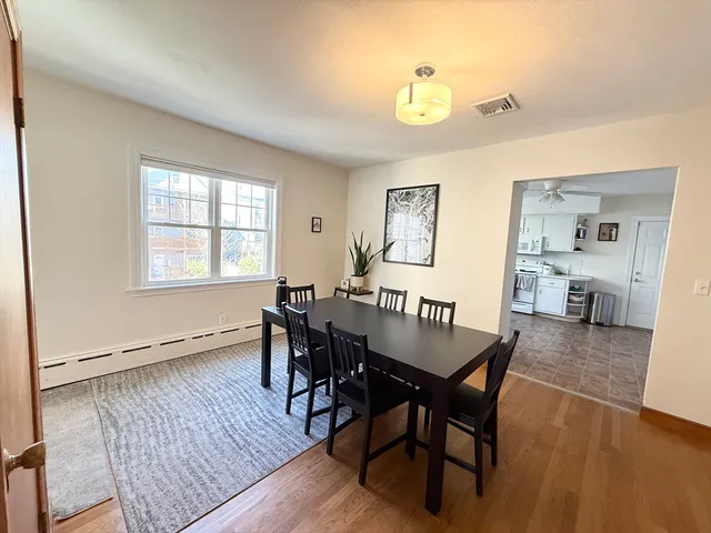 a view of a dining room with furniture and wooden floor