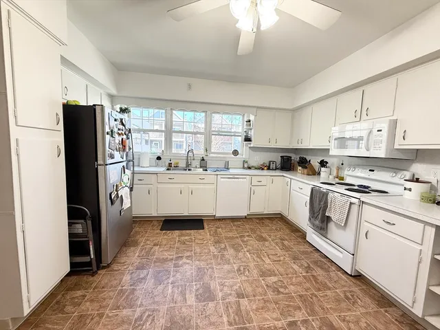a kitchen with stainless steel appliances a refrigerator sink and cabinets