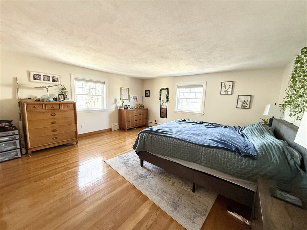 920 East 4th Street, Unit 2 Boston, MA 02127 - Photo 7 of 11 a bedroom with a bed and wooden floor