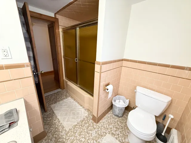 a bathroom with a toilet and a shower