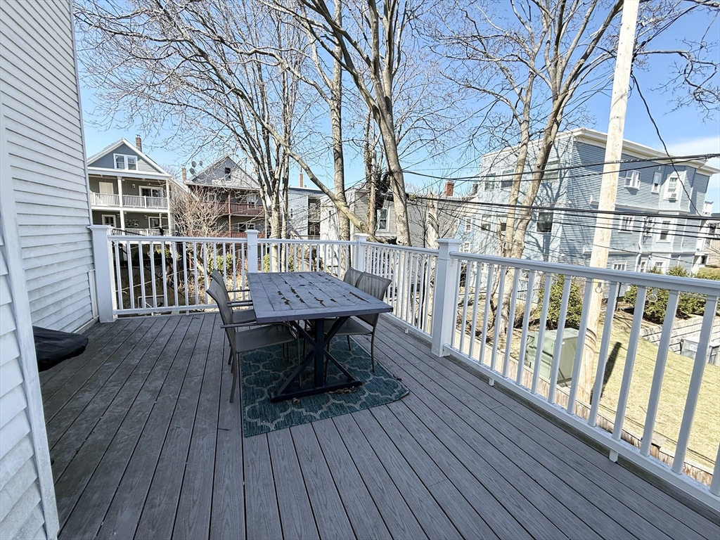 920 East 4th Street, Unit 2 Boston, MA 02127 - Photo 9 of 11 a view of a roof deck with table and chairs with wooden floor and fence