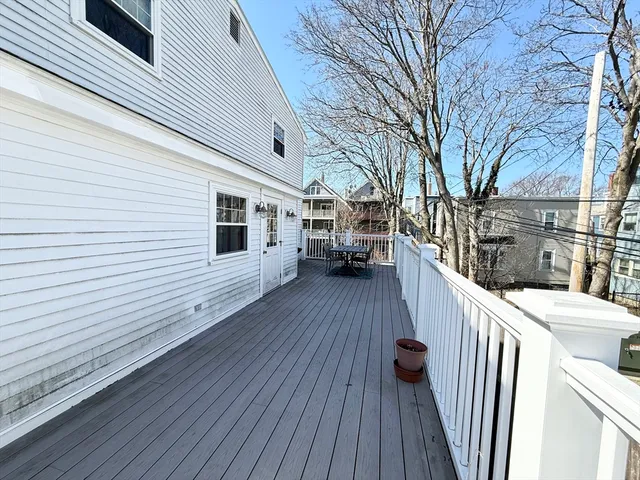 a view of a house with wooden deck