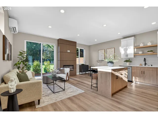 a living room with furniture a wooden floor and a large window