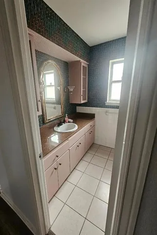 a bathroom with a sink a mirror and a bathtub