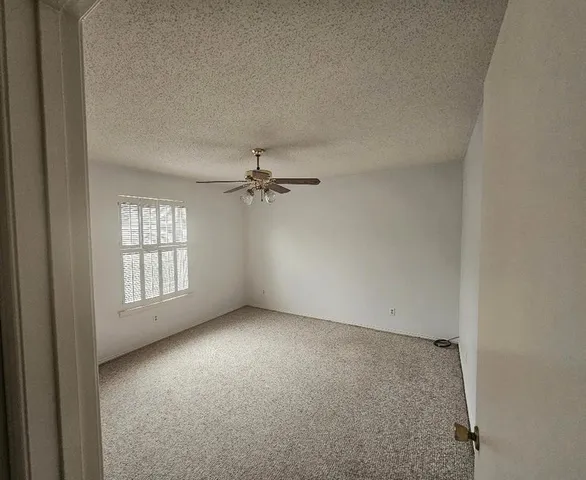 an empty room with windows and closet