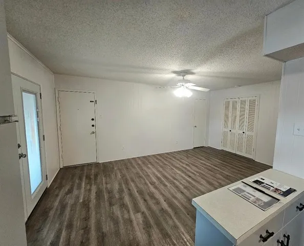 a view of a room with wooden floor and staircase
