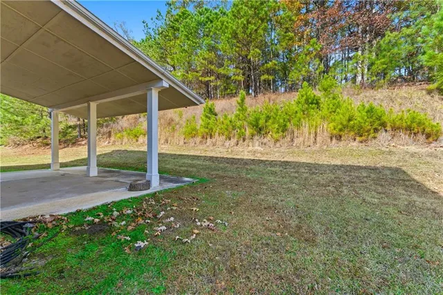 a view of a house with backyard and a tree
