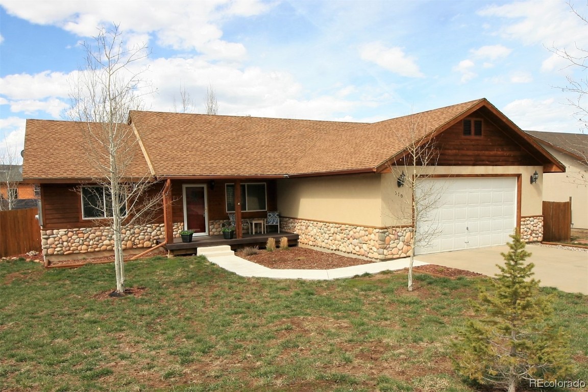 310 Honeysuckle Drive Hayden, CO 81639 - Photo 1 of 22 a front view of a house with garden