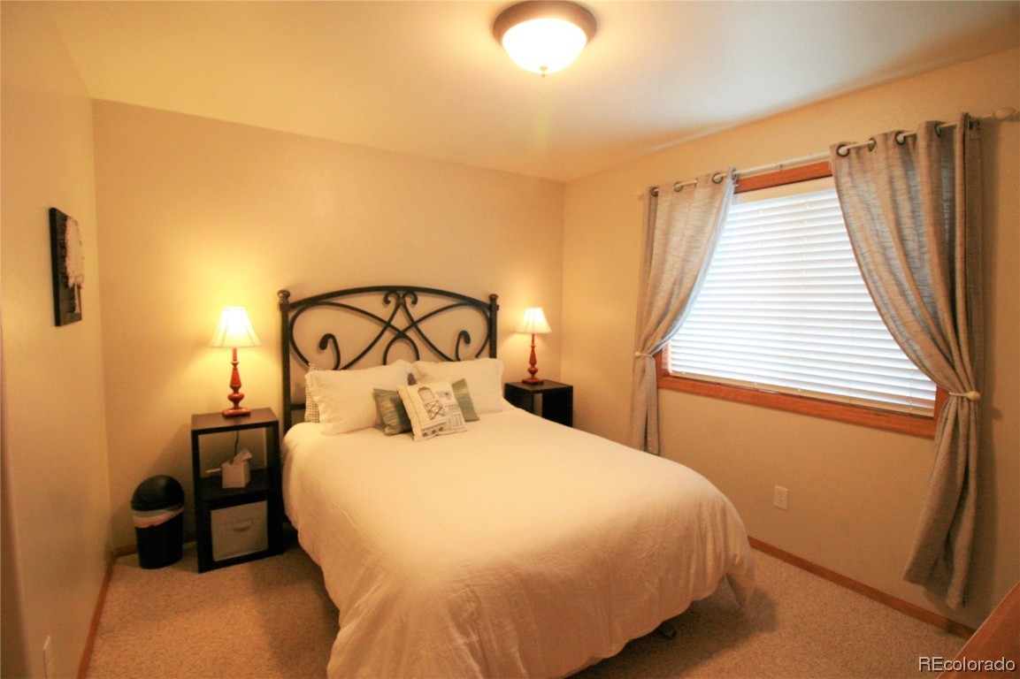310 Honeysuckle Drive Hayden, CO 81639 - Photo 14 of 22 a bedroom with a bed and a large window