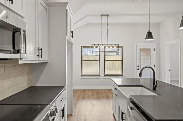 a kitchen with granite countertop a stove and a sink