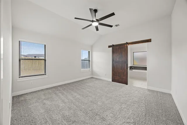 a kitchen with stainless steel appliances refrigerator wooden floor and white cabinets