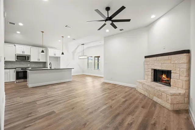 a view of a kitchen with a sink and a fireplace