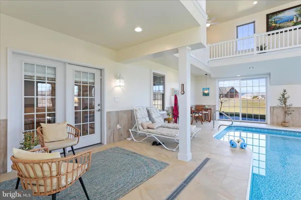 a kitchen with stainless steel appliances granite countertop a stove a refrigerator a kitchen island a dining table and chairs with wooden floor