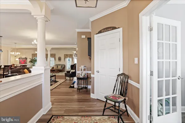 a living room with fireplace furniture and a wooden floor